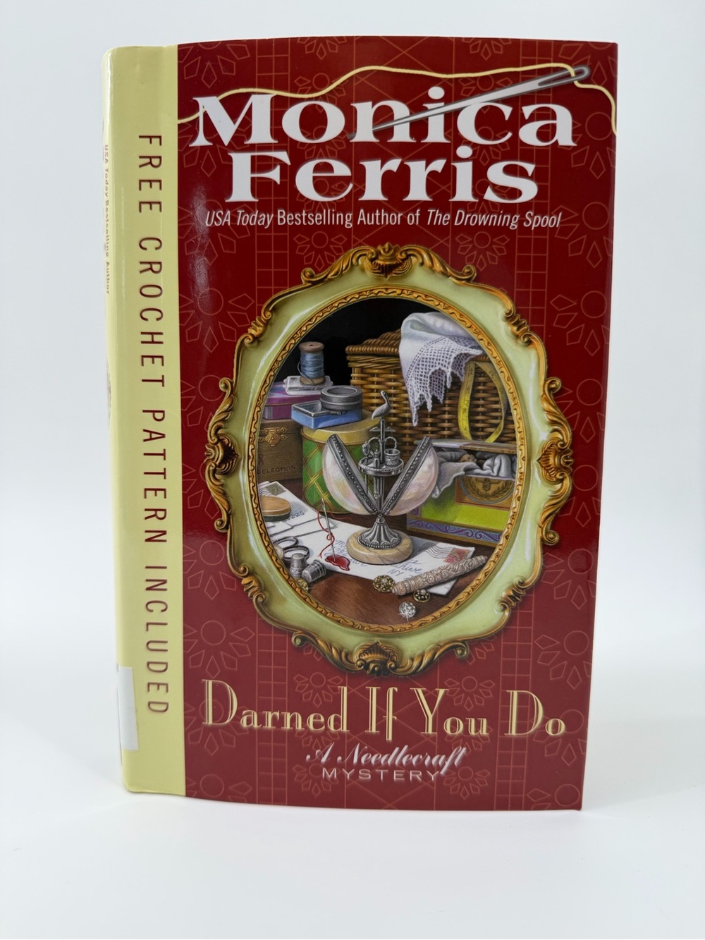 Monica Ferris "Darned If You Do" Hardcover Book - Red & Cream Cover